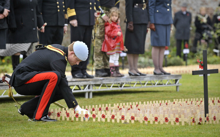 Image: Britain's Prince Harry plants a cross for Lance Corporal of Horse Jonathan Woodgate during the opening of the Royal British Legion Wootton Bassett Field of Remembrance, in the grounds of Lydiard Park in Swindon